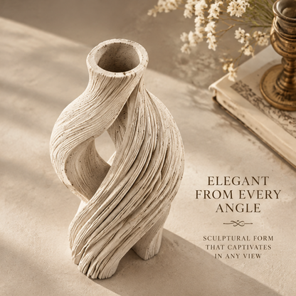 Angled top view of the cream open-loop vase showing its round neck opening and sculptural curves